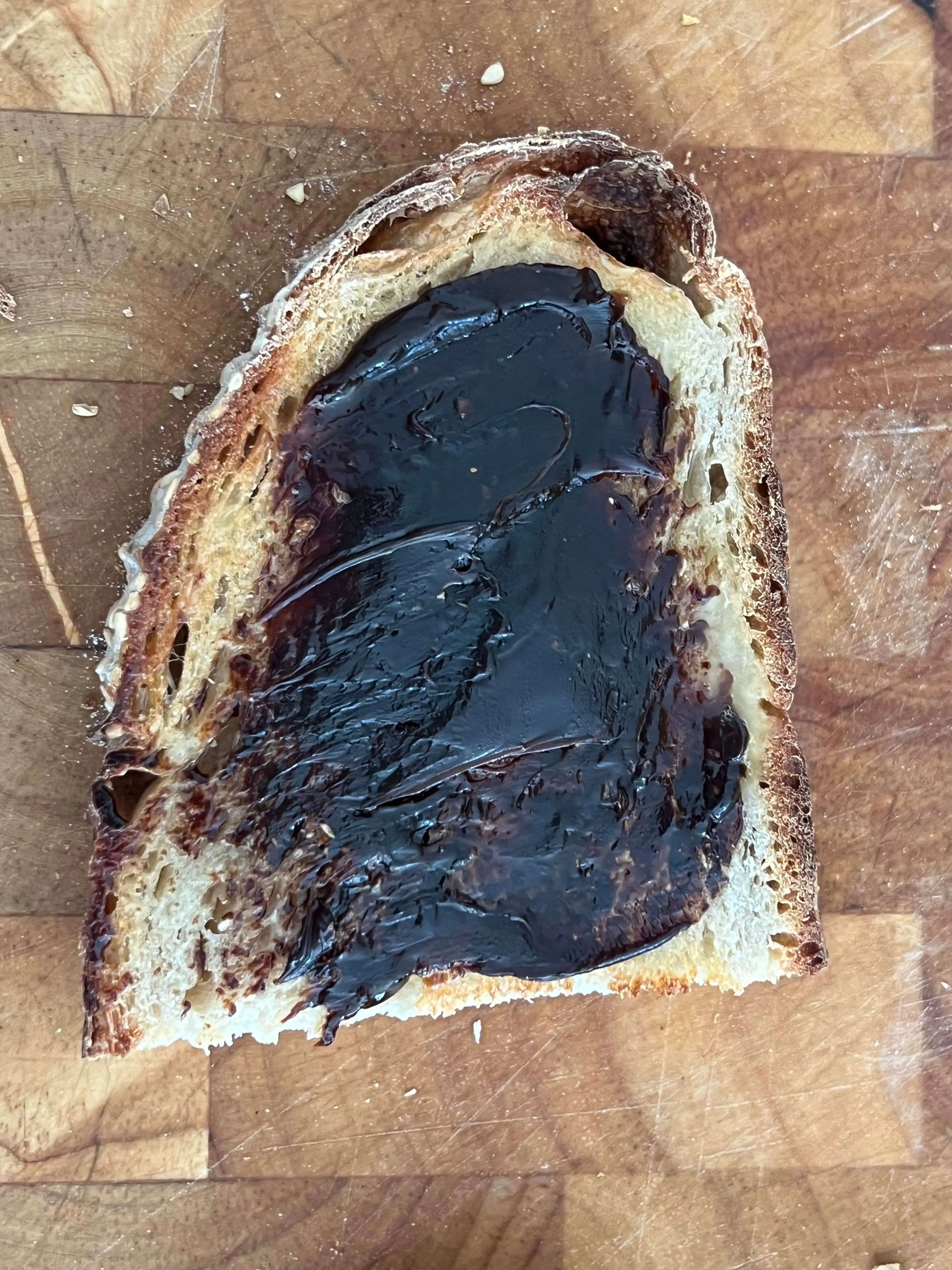 half a piece of toast with a very thick layer of Vegemite on top