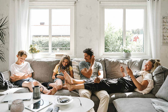 happy-family-sitting-on-sofa-in-living-room-MASF21605.jpg