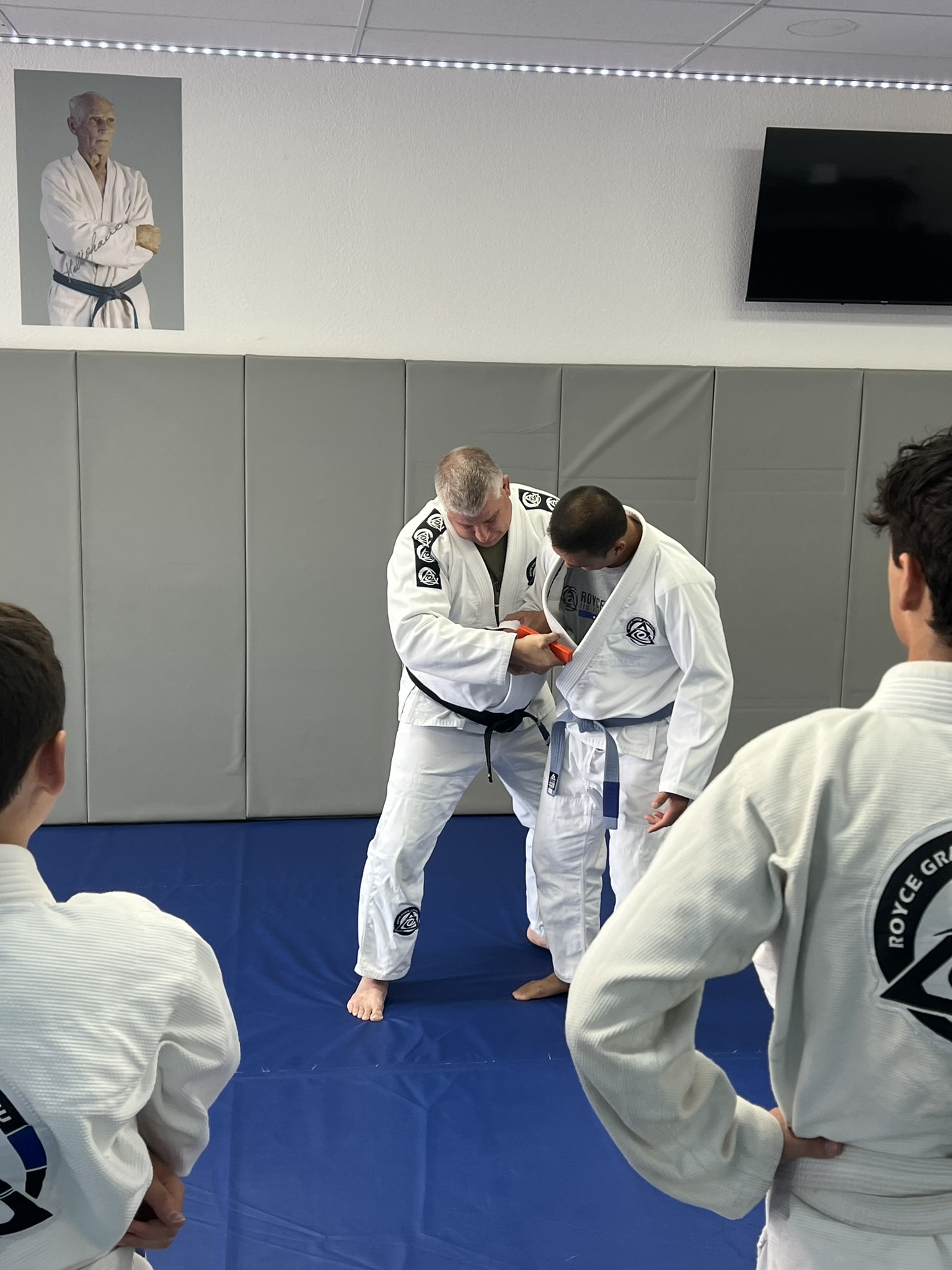 Black belt showing a gun defense on a student