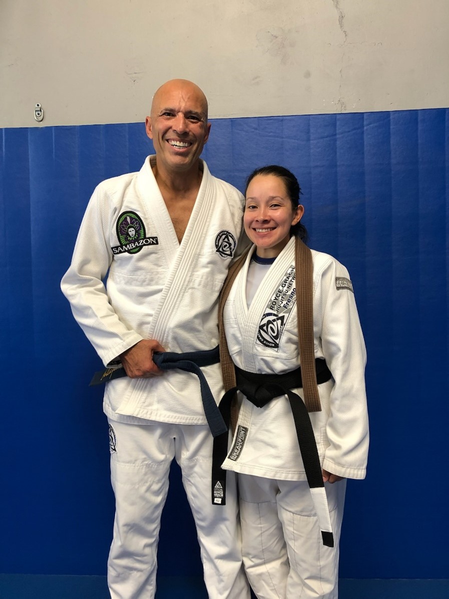 Royce poing with a new female blackbelt