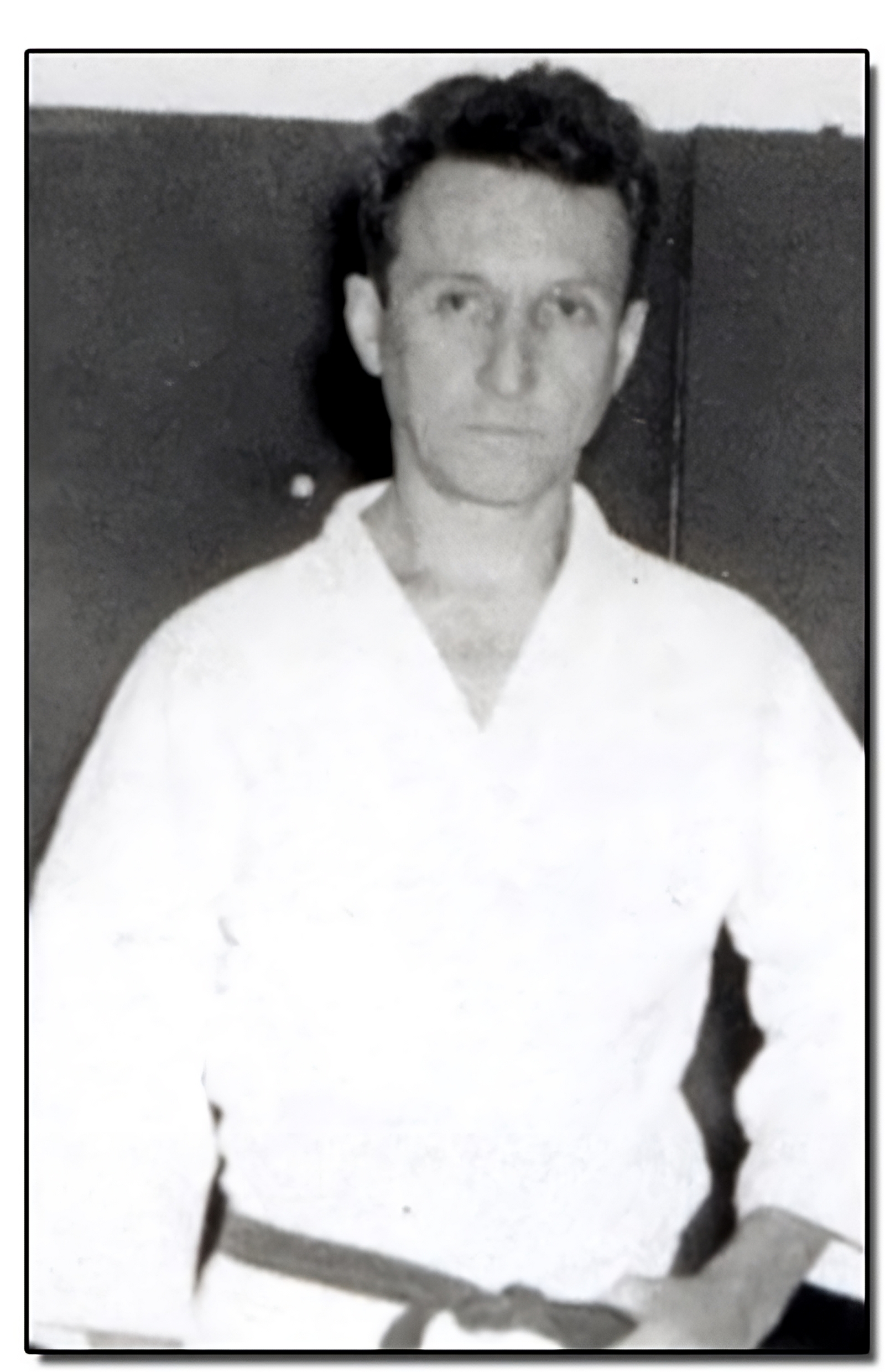 Young Carlos Gracie posing in a gi