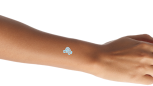 cyan swirl imprinted on arm like glowing tattoo