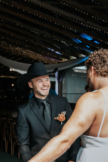 Groom laughing at his friend dressed up as a bride during the fake first look at Shylynn Ranch in Salmon Arm, BC, photographed by Cardinal Vow Media