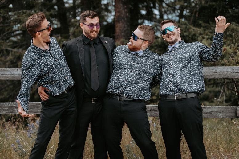 Groom and groomsmen laughing while getting ready at Kelowna BC wedding, photographed by Cardinal Vow Media