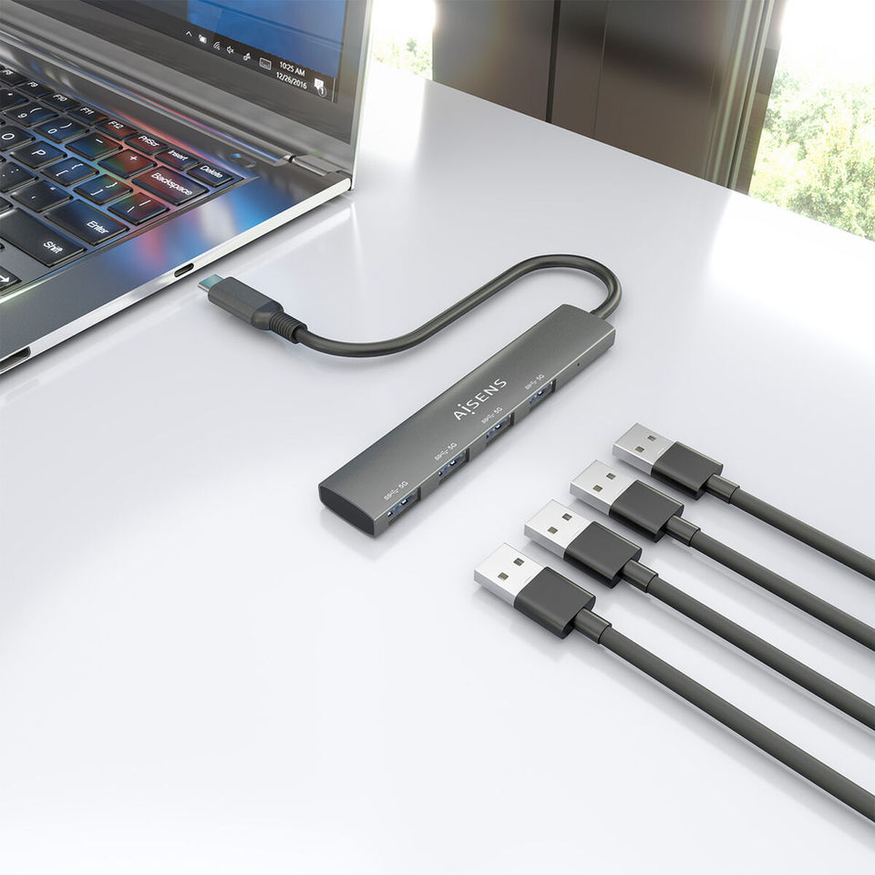 USB-C multiport hub connected to a laptop, with HDMI, USB and power delivery ports, shown alongside multiple connection cables on a desk.