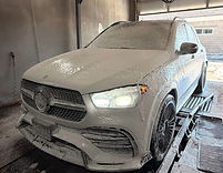 Staff performing a thorough hand wash to remove dirt and buildup, bringing the vehicle back to its like‑new shine.