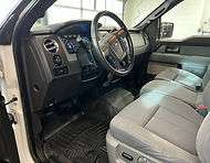 Interior cleaning for a like‑new appearance, including interior vacuuming, cleaned rubber mats, and hand‑wiped dash, console, cup holders, and door panels.