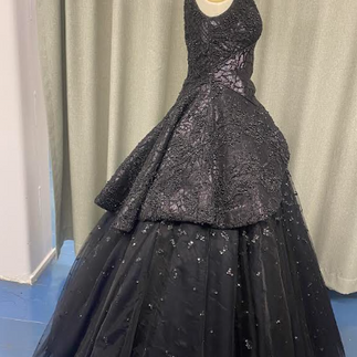Side view of a black vintage style ballgown embellished with sequins