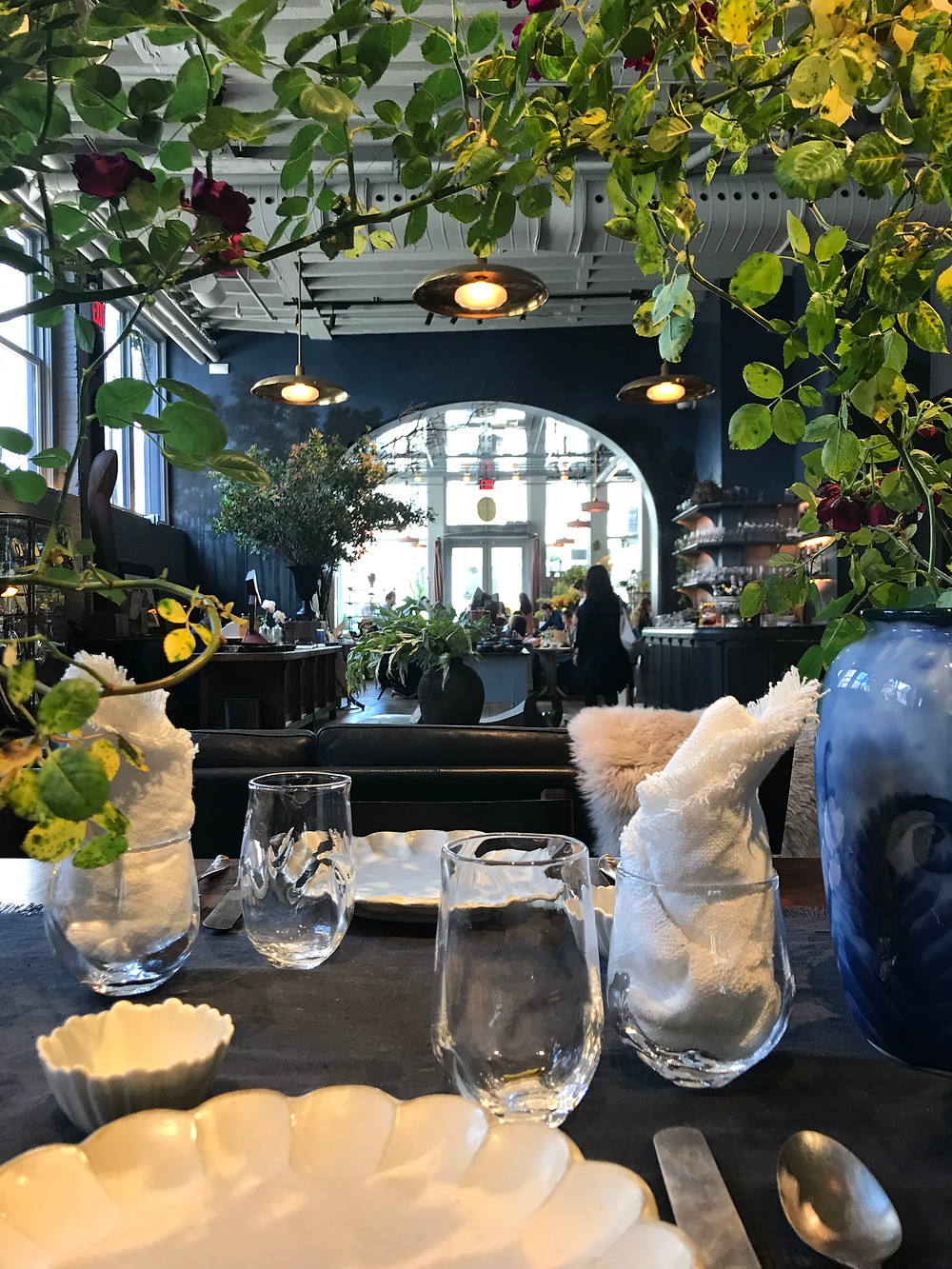 Roman and Williams store and restaurant design New York, inside plants, exposed rafters, arched entrance, new nyc restaurant, designer restaurant