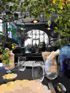 Roman and Williams store and restaurant design New York, inside plants, exposed rafters, arched entrance, new nyc restaurant, designer restaurant