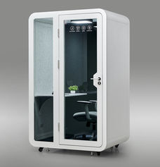 Three-quarter exterior view of a white SmartPod Solo Pod Pro privacy pod on wheels with a glass door.