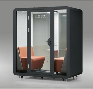 Soundproof black office pod for 2 to 4 people featuring sleek glass doors and orange seating inside an acoustic workspace.