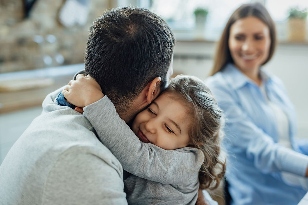affectionate-little-girl-with-eyes-closed-embracing-her-father-home-mother-is-background.j