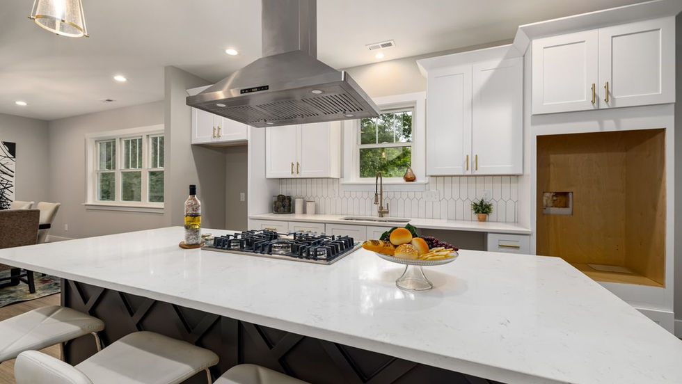 Modern Toronto kitchen with white cabinets and a stainless steel range hood above the cooktop