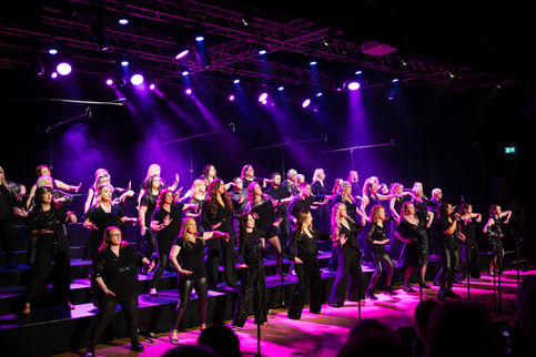 Vocalize Choir singing on stage