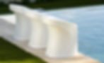 LEDGE Signature In-Pool Barstools lined up at the edge of a swimming pool