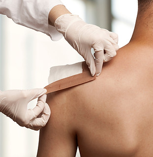 Taping a shoulder wound
