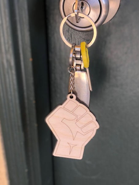 Thumbnail: Single "Nice to Meet You" Keyring keepsake in the shape of solidarity fist hanging from door knob, Juneteenth