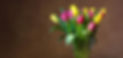 Photo of a colourful vase of tulip flowers