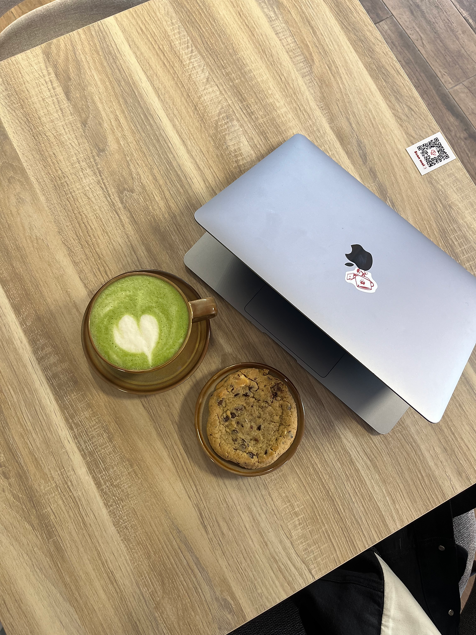 table avec un ordinateur un cookie et un matcha
