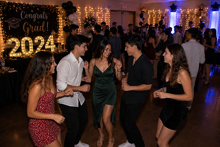 Guests dancing together during a graduation party celebration