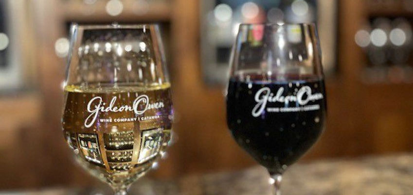 Two glasses of wine from Gideon Owen Wine Company, one red and one white.