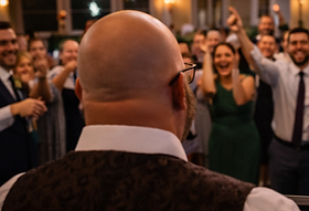 Wedding DJ performing at a packed reception dance floor in Northeast Ohio