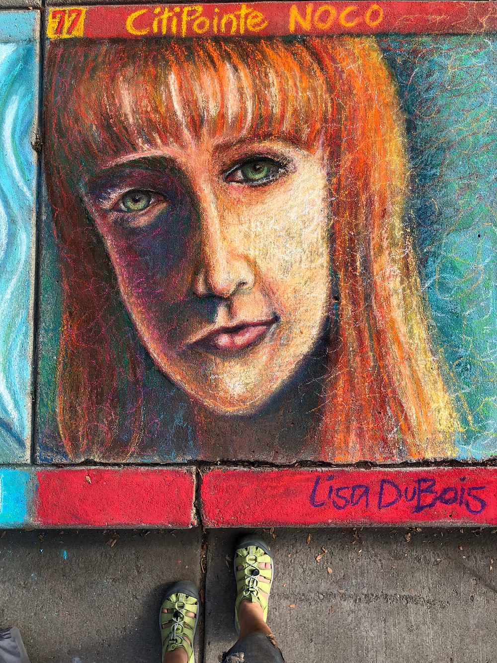 Pastel portrait of a red-headed woman, on sidewalk