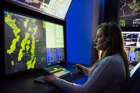 Female air traffic controller working in a radar room