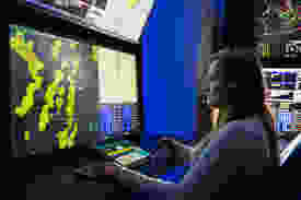 Female air traffic controller working in a radar room