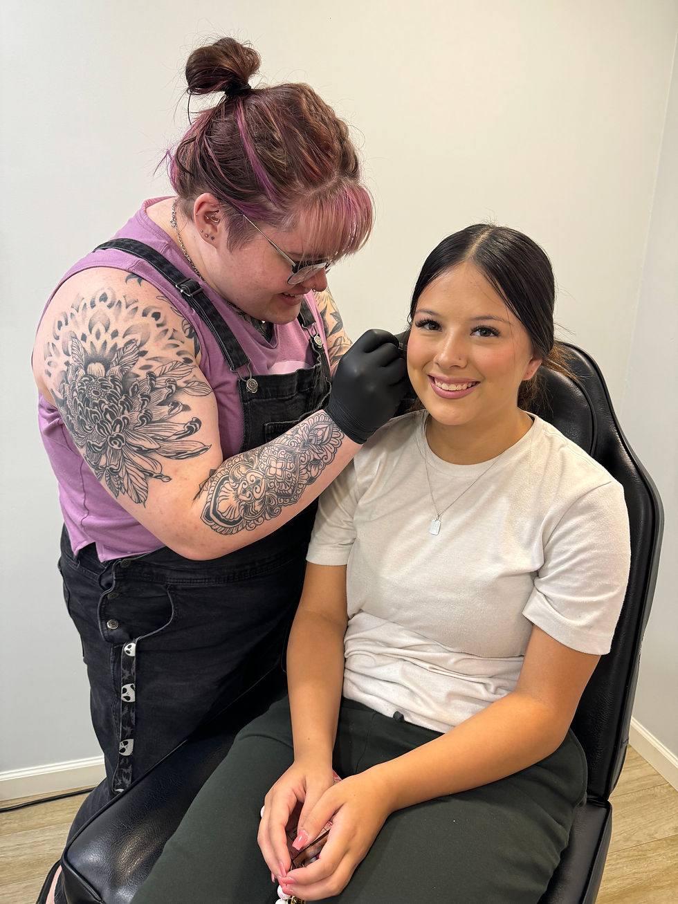 Pictured is Aubrey giving her client a 3rd earlobe piercing.