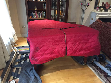 The Baby Grand Piano is protected with a professional cover and will be placed on the moving shoe.