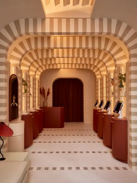 Modern interior with striped vaulted ceiling and displays
