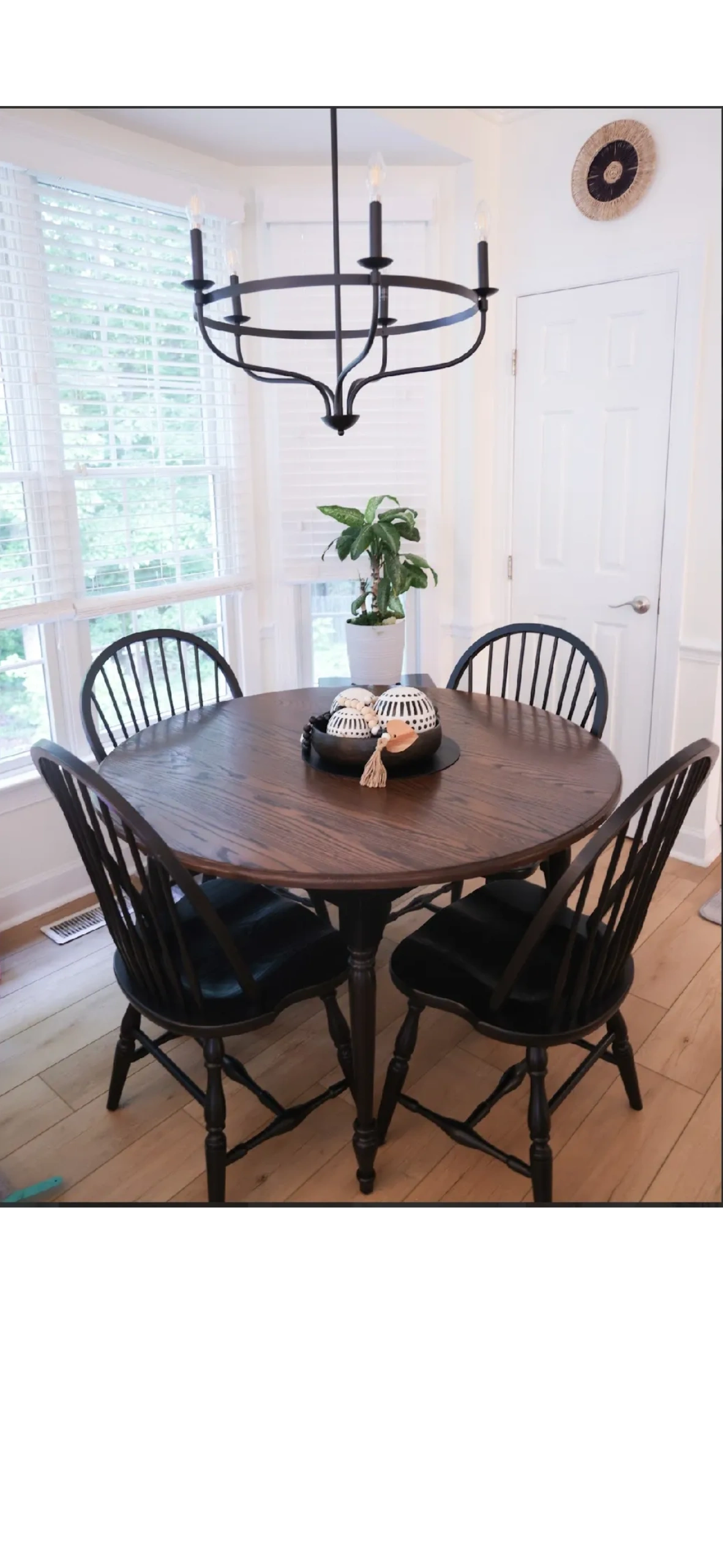 Dining nook with black chairs and chandelier