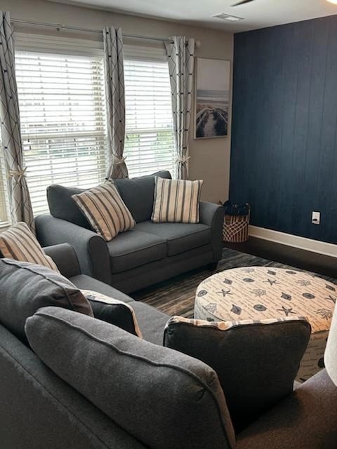 Cozy living room with grey sofas and striped cushions
