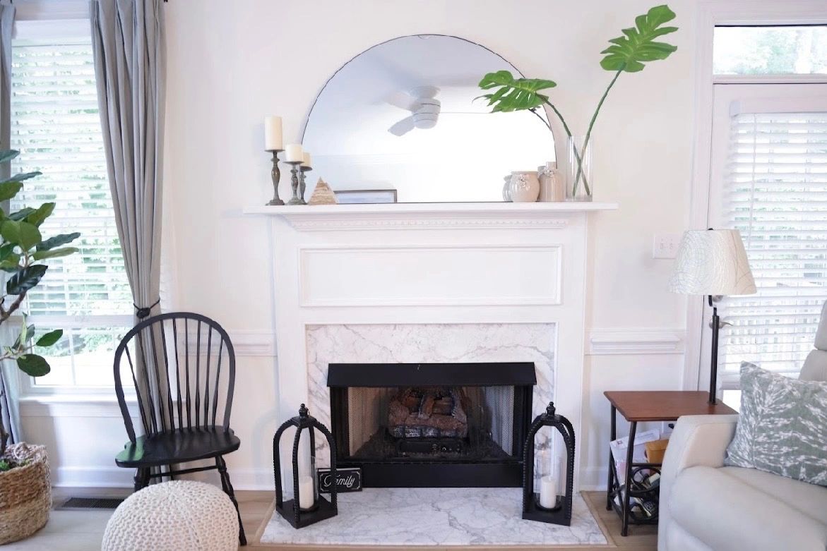 Stylish fireplace with candles and plants