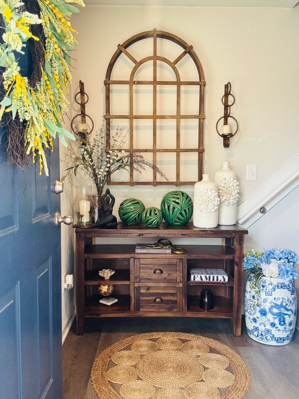 Entryway console with arched mirror and greenery