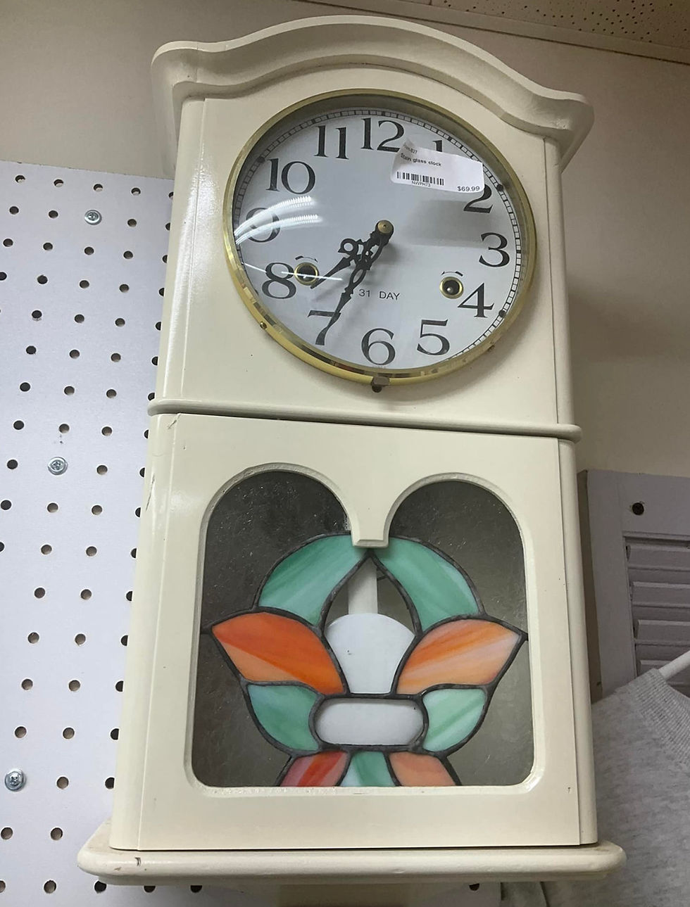 White wall clock with stained glass detail