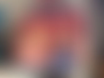 Vintage Raggedy Ann and Andy dolls on wicker shelf