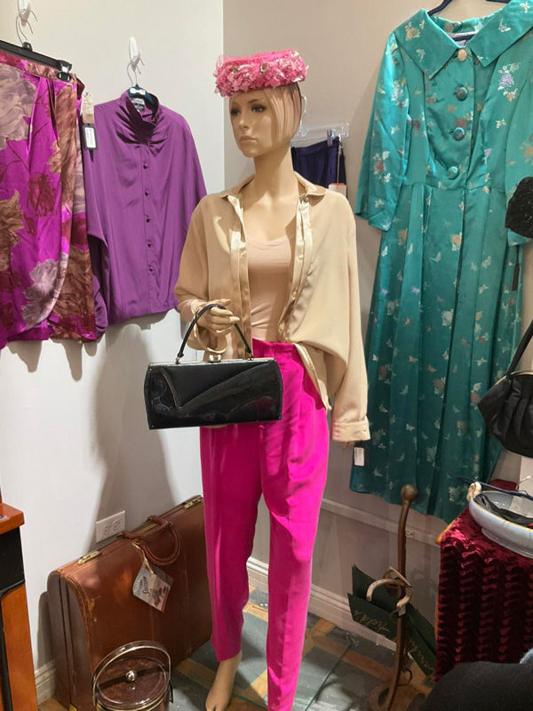 Mannequin dressed in vintage dress pants and blouse with accessories