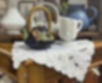 Teapot and pitcher on vintage dresser scarf