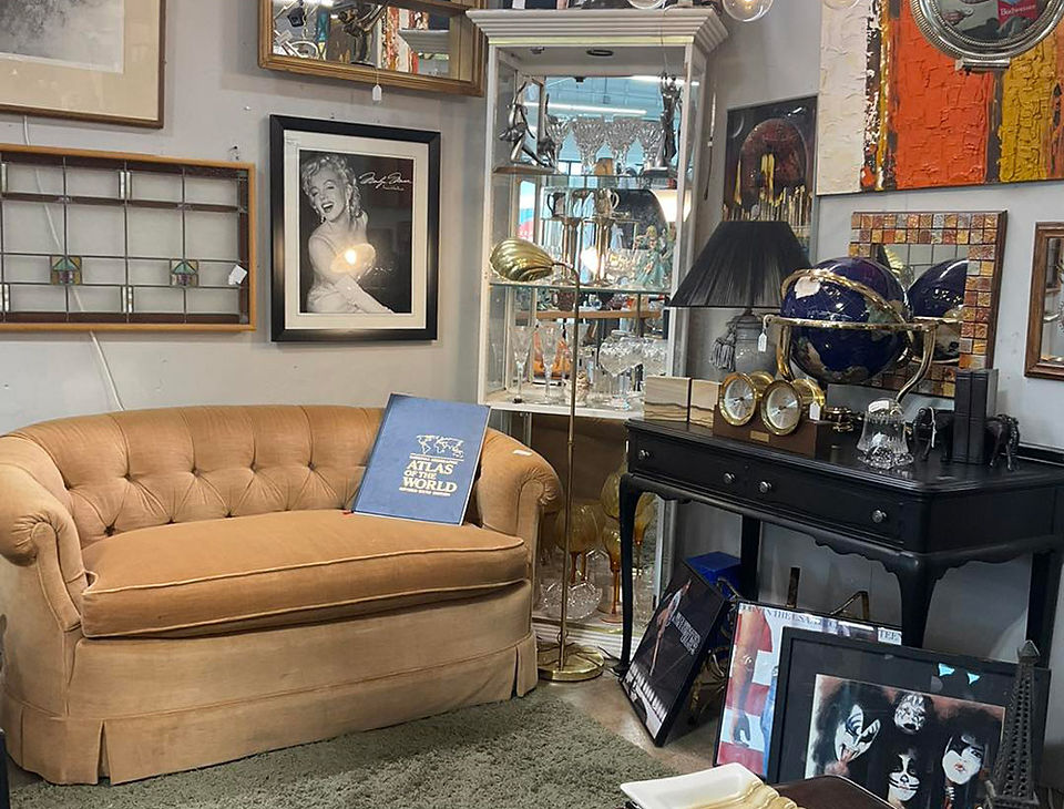 Indiana antique mall booth with loveseat and home décor