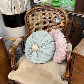 Antique cane back chair with pillows
