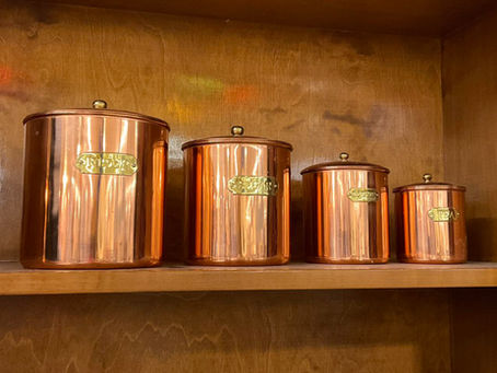 Shelf of vintage copper canisters for the kitchen