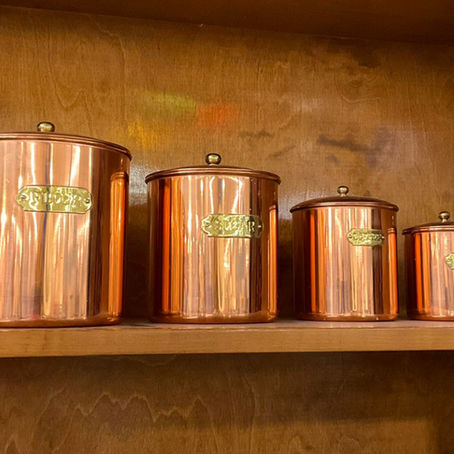 Shelf of vintage copper canisters for the kitchen