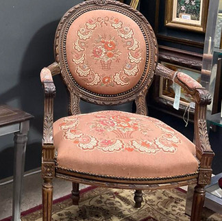 Antique wooden chair with embroidered cushion