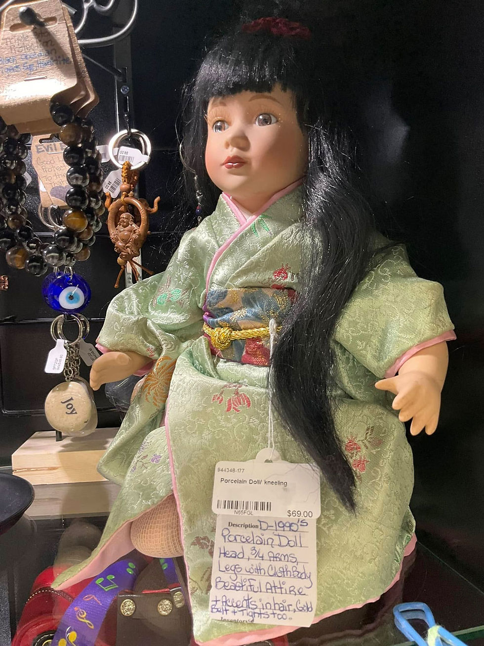 Porcelain doll in green kimono