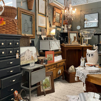 Antique mall booth with vintage furniture and decorations