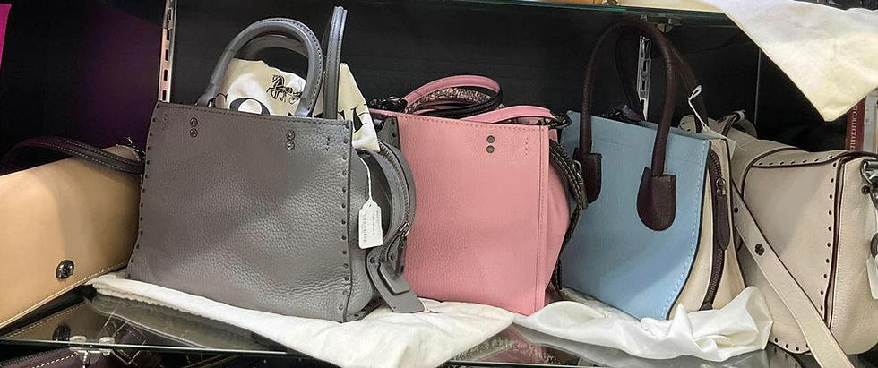 Medium Coach tote bags in showcase display