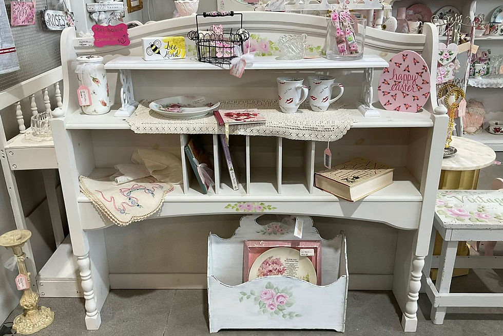 White and floral patterned décor on painted shelf